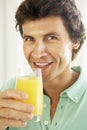 Mid Adult Man Drinking A Glass Of Orange Juice Royalty Free Stock Photo