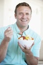 Mid Adult Man Eating Fresh Fruit Salad. Royalty Free Stock Photo