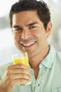 Mid Adult Man Holding A Glass Of Orange Juice Royalty Free Stock Photo