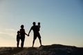 Mid adult parents and two pre-teen children standing on beach admiring view, full length, silhouette Royalty Free Stock Photo