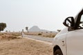 Mid adult Poor Indian village people walking alone in an empty road in a scorching hot summer day. A car point of view image. A