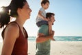 Mid adult white couple walking on a beach, dad carrying son on his shoulders, side view, close up Royalty Free Stock Photo