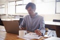 Mid-adult white man working in an office using laptop Royalty Free Stock Photo