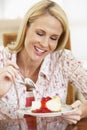 Mid Adult Woman Eating Cheesecake