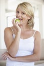 Mid Adult Woman Eating Green Apple Royalty Free Stock Photo