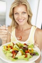 Mid Adult Woman Eating A Healthy Salad Royalty Free Stock Photo