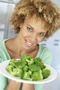 Mid Adult Woman Holding A Plate Of Broccoli Royalty Free Stock Photo