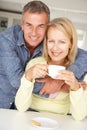 Mid age couple with coffee at home Royalty Free Stock Photo