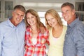 Mid age couples at home relaxing Royalty Free Stock Photo