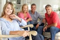 Mid age couples relaxing together at home Royalty Free Stock Photo