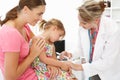 Mid age female doctor injecting young child Royalty Free Stock Photo