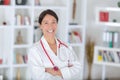 Mid age female doctor smiling arms crossed Royalty Free Stock Photo