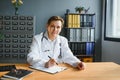 Mid age female doctor writing prescription Royalty Free Stock Photo