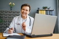 Mid age female doctor writing prescription Royalty Free Stock Photo