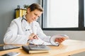 Mid age female doctor writing prescription Royalty Free Stock Photo