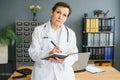 Mid age female doctor writing prescription Royalty Free Stock Photo