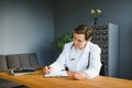 Mid age female doctor writing prescription Royalty Free Stock Photo