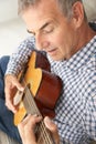 Mid age man playing acoustic guitar Royalty Free Stock Photo