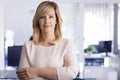 Mid aged and blond haired business woman standing at the office Royalty Free Stock Photo