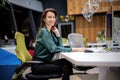 Mid aged businesswoman sitting in a modern office and using computer for work Royalty Free Stock Photo