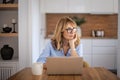 Mid aged businesswoman using laptop and working from home Royalty Free Stock Photo