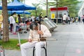 Mid-aged Chinese street musician playing Chinese traditional musical instrument-Erhu Chinese Violin in the Central Park of