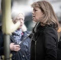 Mid-aged older woman on the street speaking with other women