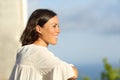 Mid aged woman contemplating from a balcony