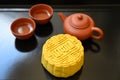 Mid-autumn festival Moon cake stuffed with nuts, durian paste and egg yolk and hot tea Royalty Free Stock Photo