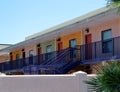 Mid-century apartment building painted in orange, green, pink, red, and purple in downtown