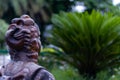 Mid close up of a Chinese empress statue from back in a garden. Buddhism and peace concept Royalty Free Stock Photo