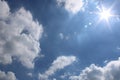 Mid day blue sky with sun clouds and lens flare Royalty Free Stock Photo