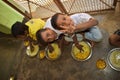 Mid day meal program, an Indian government initiative, is being running in a primary school. Pupils are taking their meal