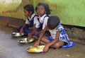 Mid day meal program, an Indian government initiative, is being running in a primary school. Pupils are taking their meal