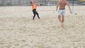 Mid-level players play beach volleyball in the park in the summer