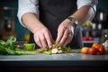 mid-preparation shot with hands layering vegetables