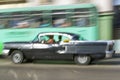 Mid-1950s black Oldsmobile speeding through Havana, Cuba