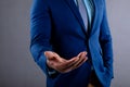 Mid section of african american businessman with cupped hand against grey background