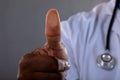Mid section of african american male doctor scanning thumb against invisible screen