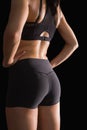 Mid section of the backside of young slim woman wearing sportswear