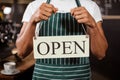 Mid section of barista holding open sign Royalty Free Stock Photo