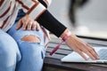 Mid section of a business woman hands typing on laptop computer, outdoors. Hands detail of woman using technology Royalty Free Stock Photo