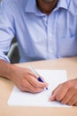 Mid section of businessman writing document at desk Royalty Free Stock Photo