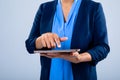 Mid section of businesswoman using a digital tablet against grey background Royalty Free Stock Photo