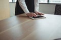 Mid section of businesswoman using digital tablet on desk Royalty Free Stock Photo