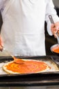 Mid section of a chef preparing pizza in kitchen Royalty Free Stock Photo