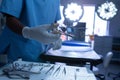 Surgeon holding surgical scissor in operating room of hospital Royalty Free Stock Photo