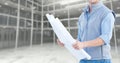 Mid section of construction engineer holding a plan Royalty Free Stock Photo