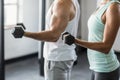 Mid section of couple exercising with dumbbells in gym Royalty Free Stock Photo