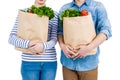 Mid section of couple holding grocery bags